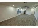 Bright and airy living room with modern flooring, white walls, and large windows at 1930 W Missouri Ave, Phoenix, AZ 85015