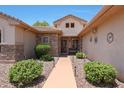 Inviting front entrance with walkway, desert landscaping, and stone accents at 19662 N Overton Ct, Surprise, AZ 85374
