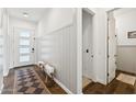 Elegant foyer with wainscoting, hardwood floors, and a stylish entry door at 21120 E Superstition Dr, Queen Creek, AZ 85142