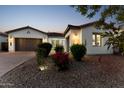 Beautiful home exterior showcasing a stone driveway, desert landscaping, and a two-car garage at 21120 E Superstition Dr, Queen Creek, AZ 85142