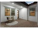Inviting outdoor patio featuring brick pavers, seating, and charming decorative touches at 21120 E Superstition Dr, Queen Creek, AZ 85142