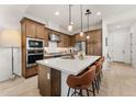 Elegant kitchen featuring an island with seating, stainless steel appliances, and ample cabinet space for storage at 23083 N 74Th Pl, Scottsdale, AZ 85255