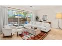Cozy living room with a white sofa, patterned rug, and sliding glass doors that open to a private outdoor patio at 23083 N 74Th Pl, Scottsdale, AZ 85255