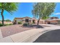 Attractive single-story home featuring stone accents, a two-car garage, and low-maintenance desert landscaping at 2514 E Grand Canyon Dr, Chandler, AZ 85249