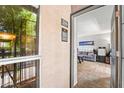 Inviting condo entryway with view into cozy living room and view of greenery from the front window at 2625 E Indian School Rd # 206, Phoenix, AZ 85016