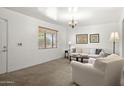 Bright living room with neutral decor, large window, and comfortable seating arrangement at 3018 E Mulberry Dr, Phoenix, AZ 85016