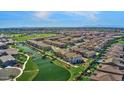 Aerial view of community featuring a pond and mountain views in the distance at 3131 S Mingus Dr, Chandler, AZ 85286