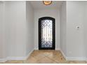 Welcoming entryway featuring neutral walls, tile floors, and a decorative wrought-iron door at 3215 E Constance Way, Phoenix, AZ 85042