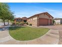 Beautiful home exterior featuring a well-manicured lawn and decorative stone accents at 3215 E Constance Way, Phoenix, AZ 85042