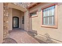 Charming front entrance featuring a decorative wrought-iron door and stylish brickwork at 3215 E Constance Way, Phoenix, AZ 85042