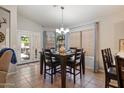 Bright dining area with backyard access and modern chandelier lighting at 3911 W Quail Ave, Glendale, AZ 85308