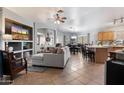 Open concept living room featuring tile floors, comfortable sofa and large television at 3911 W Quail Ave, Glendale, AZ 85308