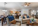 Cozy living room with tile floors open to the kitchen and dining areas at 3911 W Quail Ave, Glendale, AZ 85308
