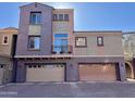 Two-story townhome with two-car garages, stucco siding, and small balcony at 3935 E Rough Rider Rd # 1066, Phoenix, AZ 85050
