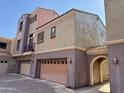 Multi-level condo exterior highlighting the attached garages and distinct architectural style at 3935 E Rough Rider Rd # 1066, Phoenix, AZ 85050
