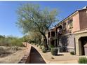 Charming condo with a private balcony, lush landscaping, and a well-maintained walkway at 3935 E Rough Rider Rd # 1066, Phoenix, AZ 85050
