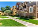 Multi-story townhome in a residential area with manicured lawns and walkways at 4072 E Windsor Dr, Gilbert, AZ 85296