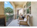 Inviting front porch with seating area offering a relaxing outdoor space with charming architectural details at 4215 E Ronald St, Gilbert, AZ 85295