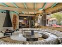 The living room features a retro conversation pit and a stone fireplace at 5331 E Mcdonald Dr, Paradise Valley, AZ 85253