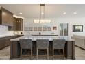 Modern kitchen with a large center island, white countertops, dark wood cabinets, and stainless steel appliances at 5332 E Thunder Hawk Rd, Cave Creek, AZ 85331