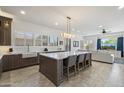 Modern kitchen with a large center island, white countertops, dark wood cabinets, and stainless steel appliances at 5332 E Thunder Hawk Rd, Cave Creek, AZ 85331