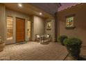 Inviting front porch featuring a cozy seating area, decorative windows, and a well-maintained brick paver walkway at 6648 S Lyon Dr, Gilbert, AZ 85298