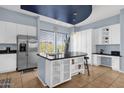 Modern kitchen with stainless steel appliances, a large island, and stylish lighting at 6745 N 93Rd Ave # 1158, Glendale, AZ 85305