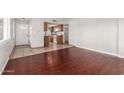 Bright living space featuring dark wood floors and access to the kitchen at 725 S Power Rd # 101, Mesa, AZ 85206