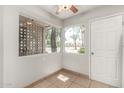 Cozy room featuring tiled floor, neutral paint, and windows with a neighborhood view at 725 S Power Rd # 101, Mesa, AZ 85206