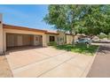 Charming single-story home featuring an open carport and well-maintained front yard landscaping at 9106 N 68Th Ln, Peoria, AZ 85345