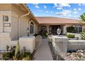 Inviting walkway to the home's entrance with desert landscaping, and arched window at 10152 E Aster Dr, Scottsdale, AZ 85260