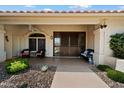 Charming front porch with seating, decorative accents, and decorative metal doors at 10152 E Aster Dr, Scottsdale, AZ 85260