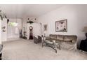 Inviting living room with neutral carpet, high ceilings, and comfortable furnishings at 11518 W Dana Ln, Avondale, AZ 85392