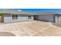 Charming single-story home with a well-manicured front yard and spacious two-car garage on a sunny day at 12021 S Tomi Dr, Phoenix, AZ 85044