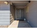 A close-up of an inviting front entrance with security doors and sidelight window at 12021 S Tomi Dr, Phoenix, AZ 85044