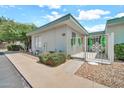 Charming single-story home with white exterior, front yard decor, and well-maintained landscaping at 13207 N 98Th Ave # L, Sun City, AZ 85351