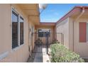 Inviting entrance with a decorative iron gate and well-manicured greenery at 13224 N 98Th Ave # L, Sun City, AZ 85351