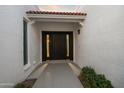 View of front door entrance with tile roofing and decorative window at 14029 N Burning Tree Pl, Phoenix, AZ 85022
