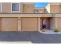 Attached garage doors and painted entry doors at this condo provide covered parking and entry for residents at 1411 E Orangewood Ave # 237, Phoenix, AZ 85020
