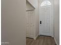 Bright foyer featuring a white front door with decorative glass and wood-look flooring at 1444 E Boston St, Chandler, AZ 85225