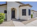 Close up of the front entry featuring an elegant dark wood door and decorative architectural details at 1444 E Boston St, Chandler, AZ 85225