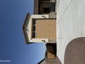 Attached two car garage with stone facade and beige door, showcasing convenient home access at 17304 W Royal Palm Rd, Waddell, AZ 85355