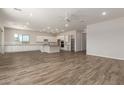 Spacious living room with wood-style flooring, recessed lighting, and plenty of room to gather with Gathering at 17304 W Royal Palm Rd, Waddell, AZ 85355