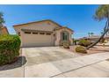 Inviting front exterior showcasing a two-car garage, desert landscaping, and a well-maintained lawn, creating excellent curb appeal at 17649 W Buchanan St, Goodyear, AZ 85338