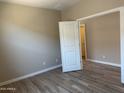 Neutral bedroom features wood floors, a closet, and a bright, airy space at 18354 W Patrick Ln, Surprise, AZ 85387
