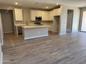 Bright kitchen features white cabinets, stainless steel appliances, and an island at 18354 W Patrick Ln, Surprise, AZ 85387