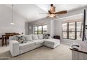 Inviting living room features high ceilings, a large window, and a comfortable sofa at 20660 N 40Th St # 2124, Phoenix, AZ 85050
