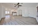 Bright open-concept living room with new flooring, neutral walls, and a ceiling fan at 21833 N 34Th Ave, Phoenix, AZ 85027