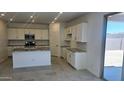 Well-lit kitchen featuring modern appliances, granite countertops, and a center island with a sink at 22655 W Mohawk Ln, Surprise, AZ 85387