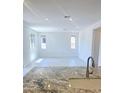 Spacious living room with tiled floors and an abundance of natural light at 22655 W Mohawk Ln, Surprise, AZ 85387